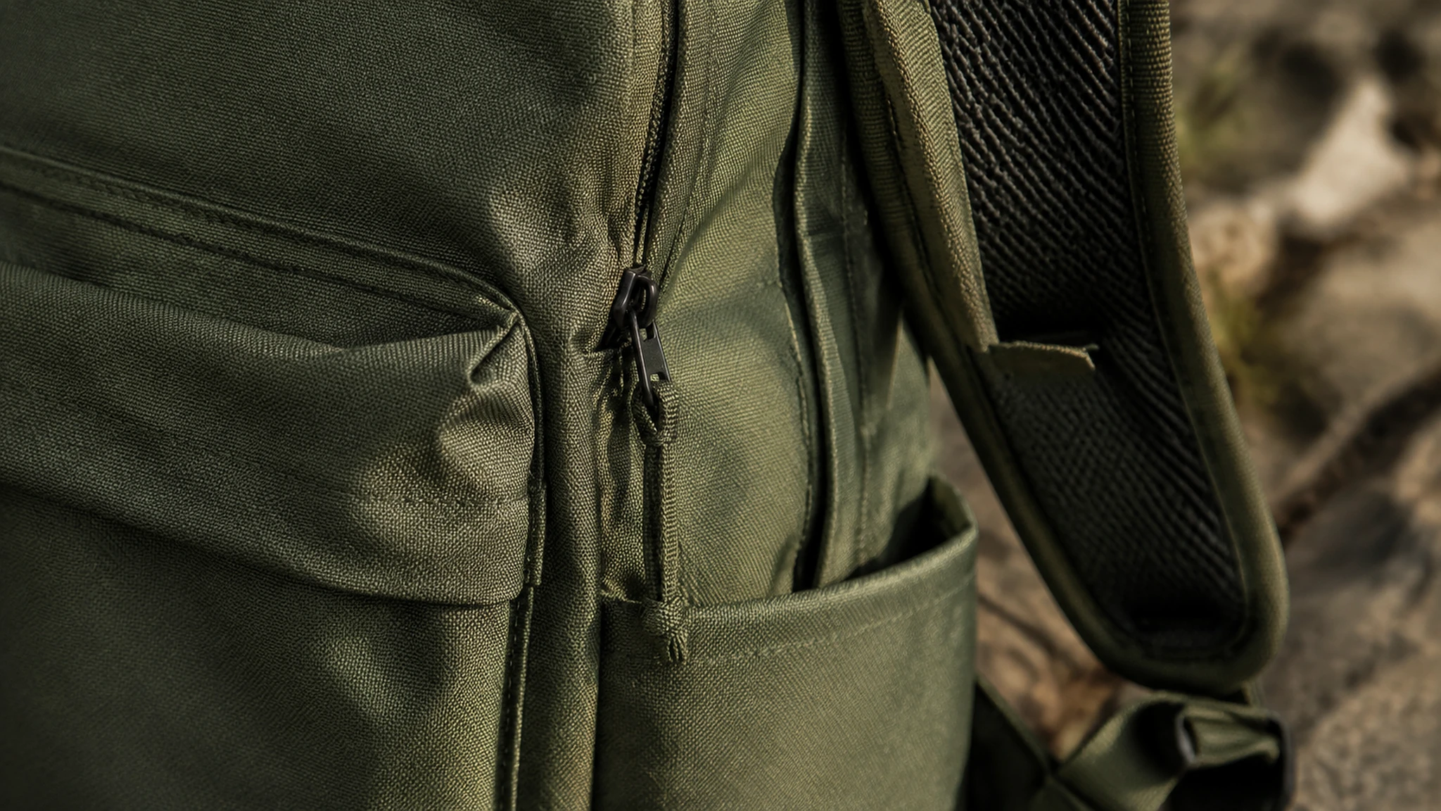 A product detail composition with the backpack's material and construction in view