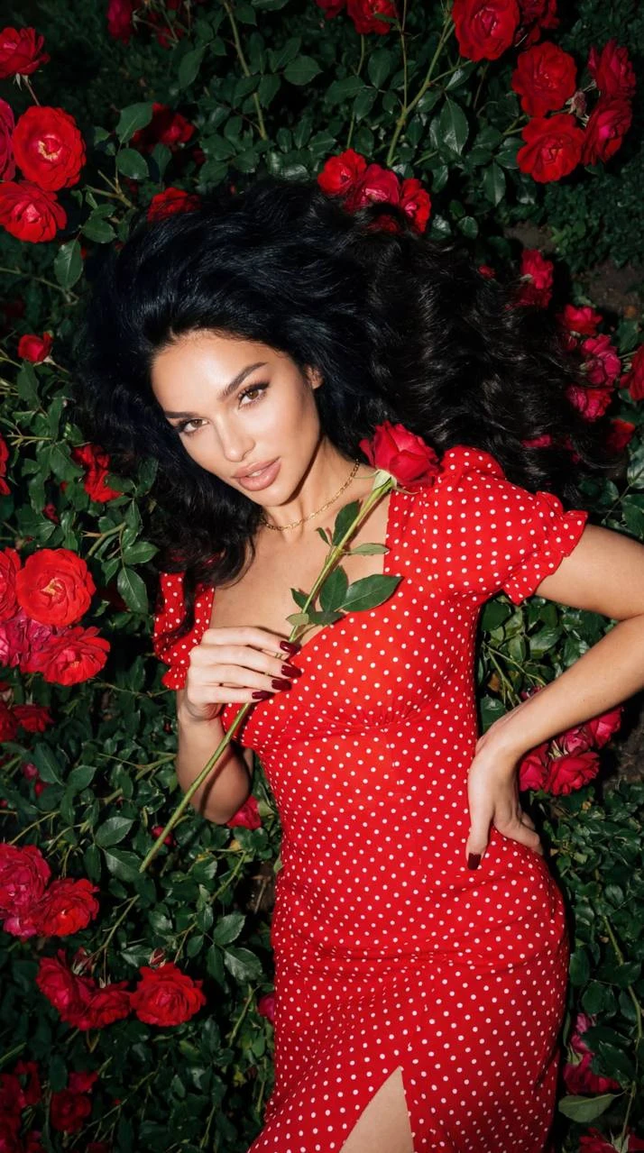 woman in red polka dress roses